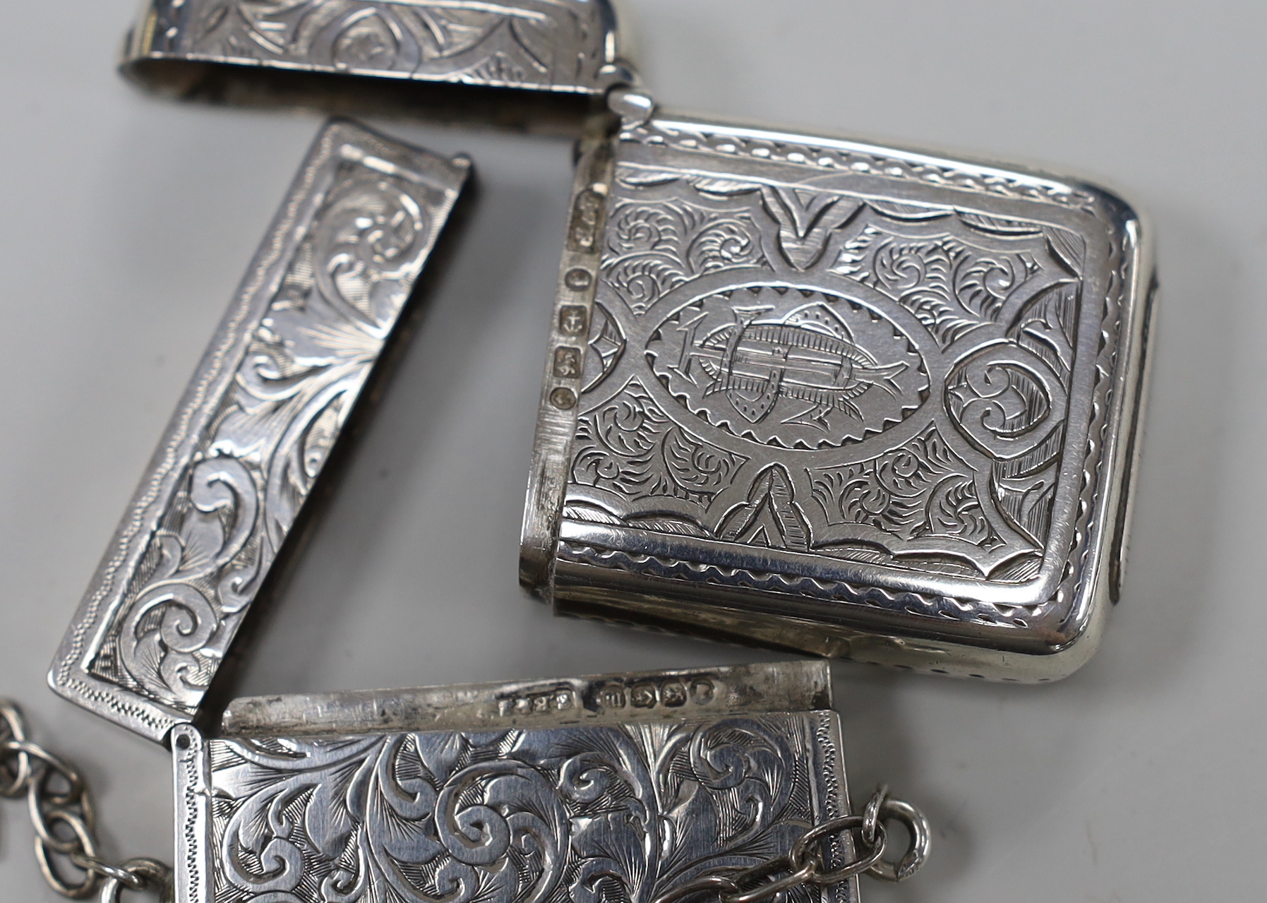 A late Victorian chased silver card case, S. Blanckensee & Son Ltd, Birmingham, 1886, 76mm and a Victorian silver vesta case.